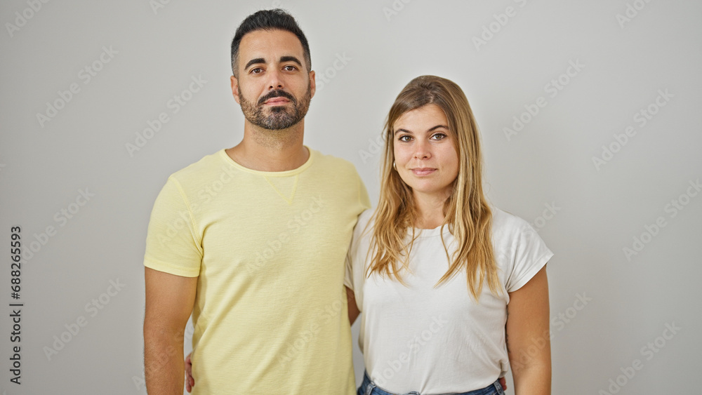 Man and woman couple hugging each other standing with relaxed face over isolated white background Man and woman couple hugging each other standing with relaxed face over isolated white background