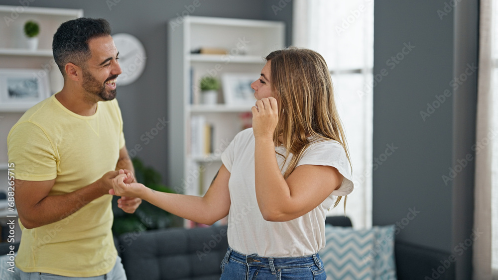 Man and woman couple dancing together at home Man and woman couple dancing together at home