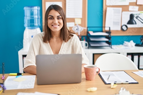 Young beautiful hispanic woman business worker using laptop working at office