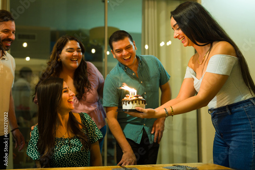 Wall Mural Beautiful friends singing happy birthday with a cake