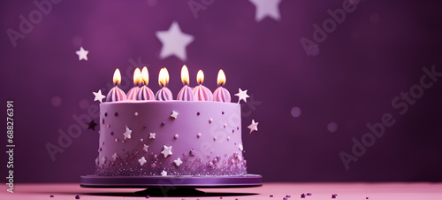 Purple birthday cake with candles on a purple background with stars and space for text photo