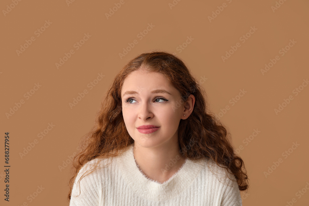 Portrait of ashamed young woman on brown background Portrait of ashamed young woman on brown background