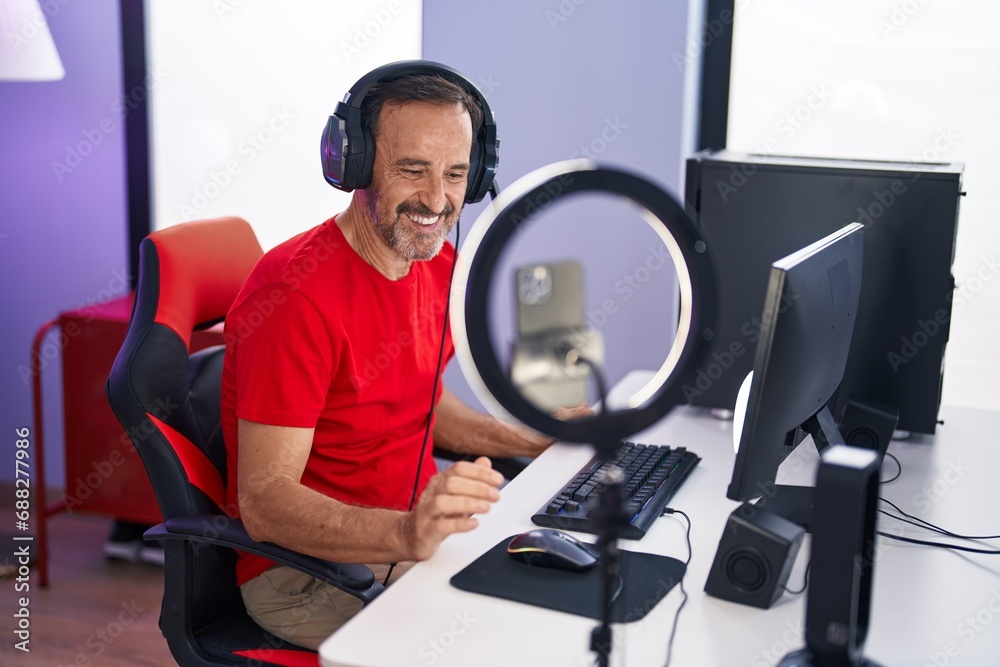 Middle age man streamer smiling confident having video call at gaming room Middle age man streamer smiling confident having video call at gaming room