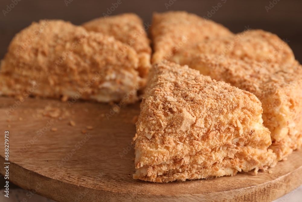 Pieces of delicious Napoleon cake on board, closeup Pieces of delicious Napoleon cake on board, closeup