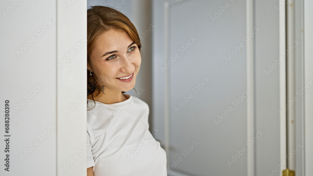 Young woman leaning on door smiling at home