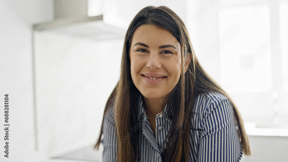 Young beautiful hispanic woman smiling happy at the kitchen Young beautiful hispanic woman smiling happy at the kitchen