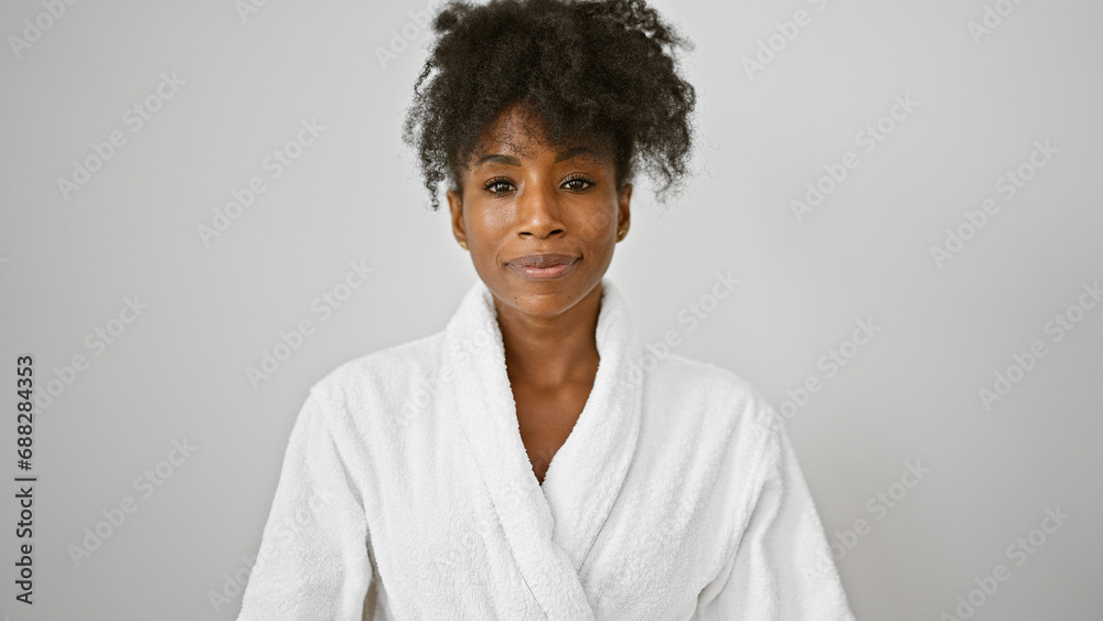 African american woman wearing bathrobe standing with serious face over isolated white background - obrazy, fototapety, plakaty 