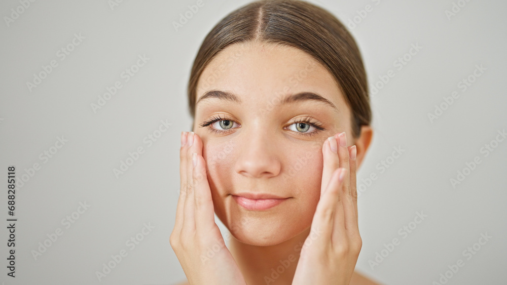 Young beautiful girl massaging face over isolated white background Young beautiful girl massaging face over isolated white background
