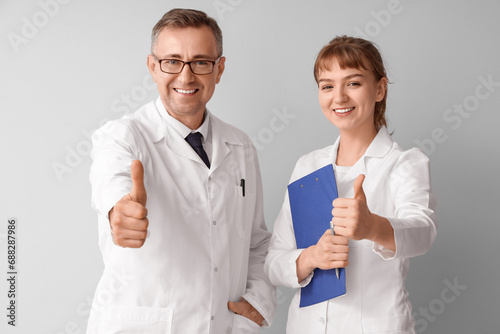 Mature doctor with his assi...
