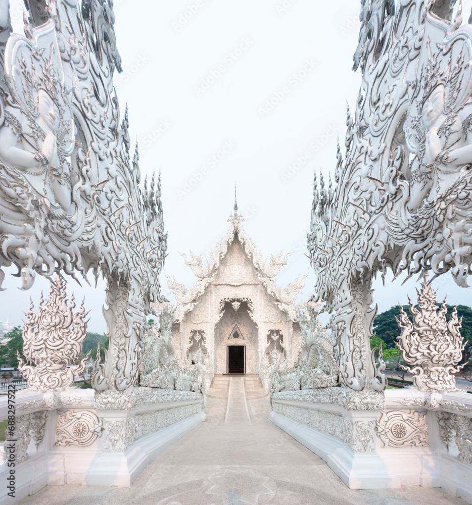 Ornamental bridge crossing into Wat Rong Khun,fantastical White Temple,outskirts of Chiang Rai,Northern Thailand.
