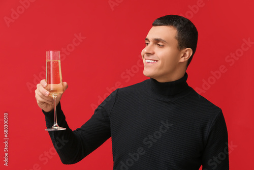 Young man with glass of cha...