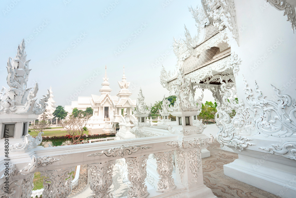 Amongst surreal structures,in the grounds of Wat Rong Khun,fantastical White Temple,Chiang Rai Province,Northern Thailand.