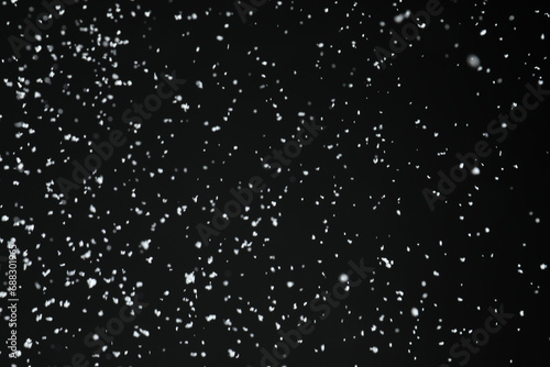 White snow falling down on black background © New Africa