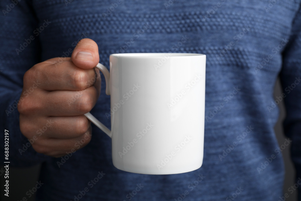 Man holding white mug, closeup. Mockup for design Man holding white mug, closeup. Mockup for design