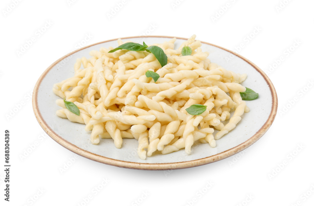 Plate of delicious trofie pasta with basil leaves isolated on white
