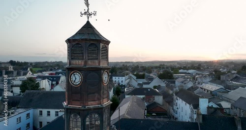 Ancient clock tower, the camera flies over the roofs of the old city photo