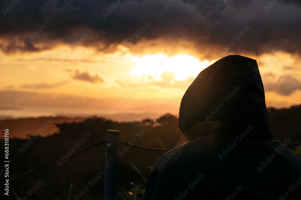 Person watching beautiful sunset in nature