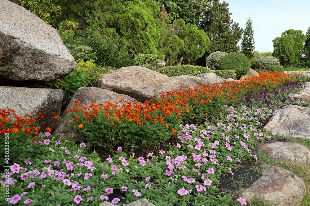 Scenic View of a Beautiful Flower Style Landscape Garden with a Green Mowed Lawn and Colourful Flower Bed with Selective Focus. Scenic View of a Beautiful Flower Style Landscape Garden with a Green Mowed Lawn and Colourful Flower Bed with Selective Focus.