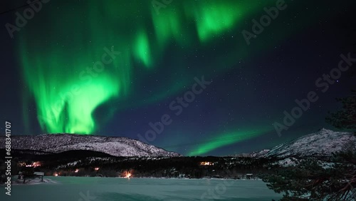 An exceptionally strong aurora dancing above a frozen lake in early December. photo