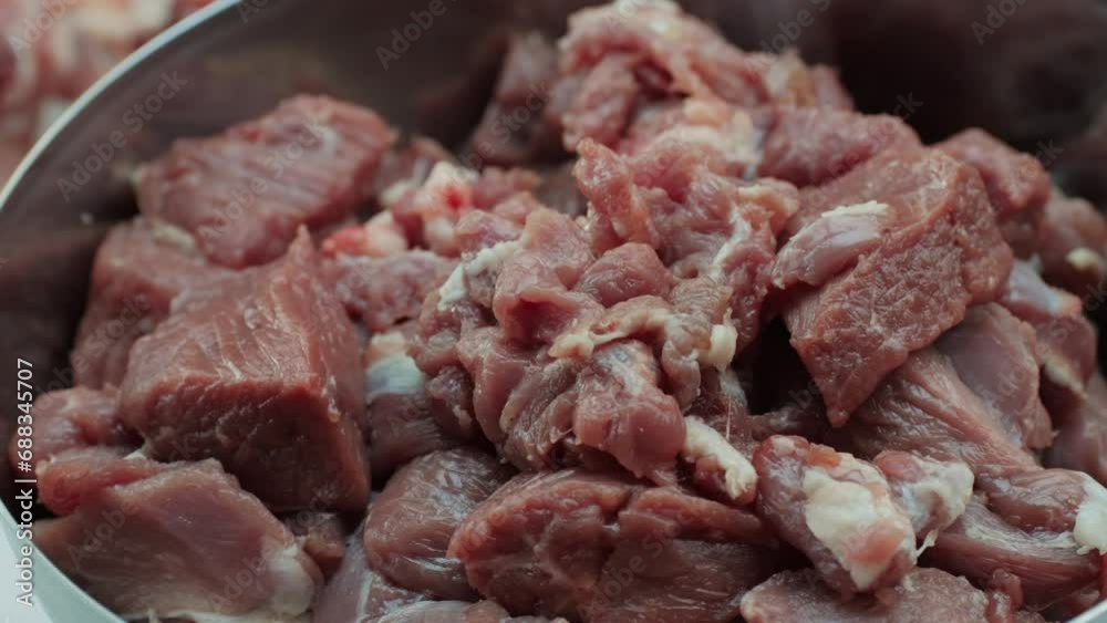 Raw mutton in metall bowl close-up. Muttons meat for uzbek pilaf. Turkey food. Chef preparing a bif piece of fresh raw meat Raw mutton in metall bowl close-up. Muttons meat for uzbek pilaf. Turkey food. Chef preparing a bif piece of fresh raw meat