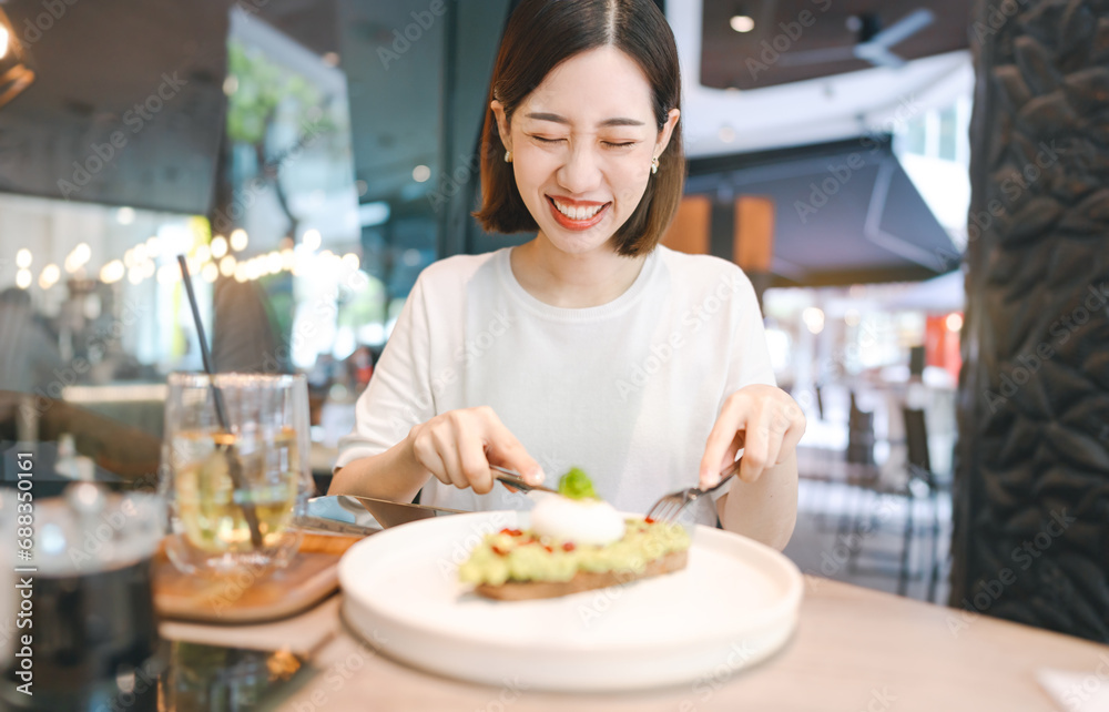 Asian foodie woman eating healthy food at cafe restaurant city break on weekend lifestyle