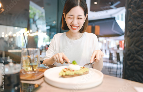 Asian foodie woman eating healthy food at cafe restaurant city break on weekend lifestyle