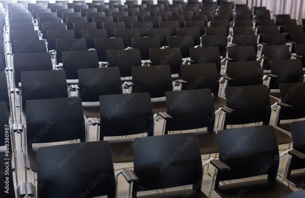 Fototapeta premium Close up of dark plastic chairs in conference room