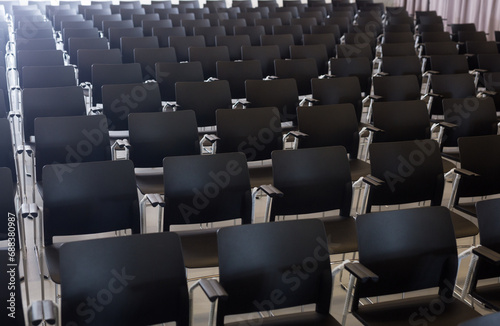 Close up of dark plastic chairs in conference room