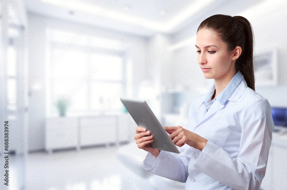 Young female dentist using a modern digital tablet Young female dentist using a modern digital tablet