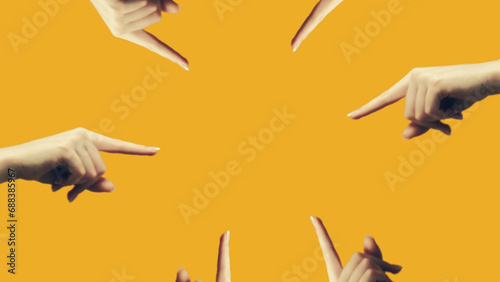 Finger pointing. Advertising background. Mirrored female hand showing recommending something in frame center isolated on yellow empty space illustration.