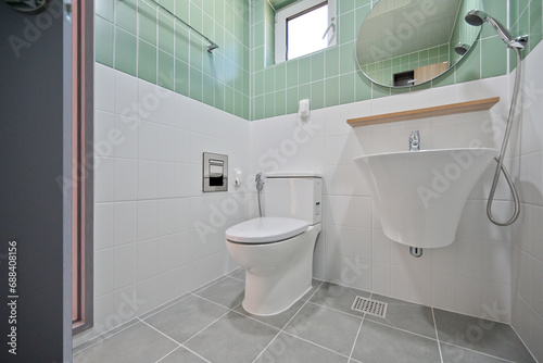 A small and cute bathroom with mint-colored tiles