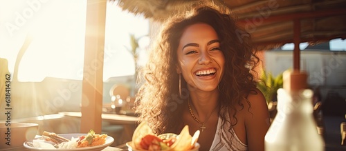 Joyful Latin woman enjoying Mexican tacos at a restaurant terrace in Mexico, during a sunny day.