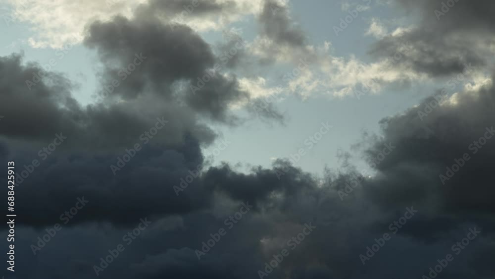 Time lapse of dark clouds moving with blue patches of sky Time lapse of dark clouds moving with blue patches of sky