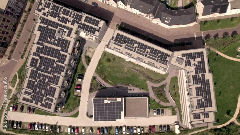 Top down aerial descend showing rooftops full of solar panels on social