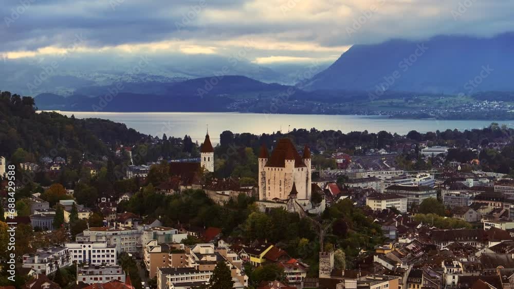 Aerial cinematic drone Thun Bern Switzerland Swiss village city downtown lake cars stunning Thun Castle Dukes of Zährigen Interlocken Jungfrau cloudy sunrise sunset circle slowly right movement