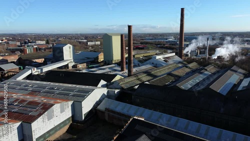 Pilkington glass factory warehouse buildings aerial view dolly left across industrial town manufacturing facility photo