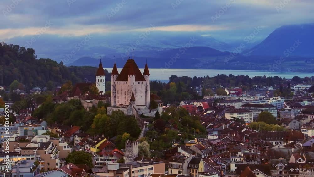 Aerial cinematic drone downtown  Thun Switzerland cars Swiss village city downtown stunning Thun Castle Dukes of Zährigen Interlocken Bern Jungfrau cloudy sunrise sunset circle slowly left movement