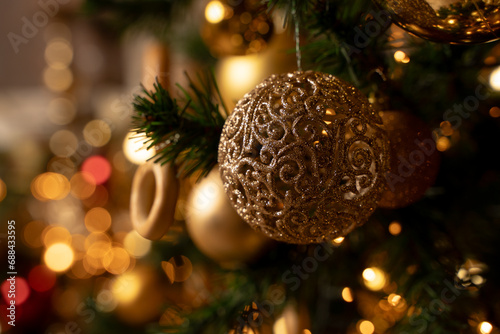 A golden sparkling ball on a Christmas tree