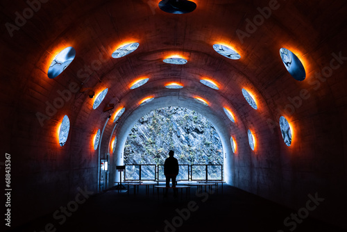 Kiyotsu Gorge Tunnel of Light with many round mirror reflection and art space theme design landmark tourist spot with silhouette human stand alone at Tokamachi, Niigata, Japan