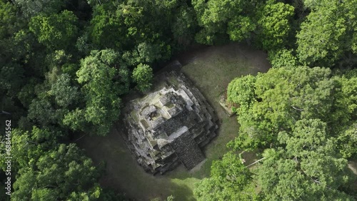 Flying above famous yaxha maya ruins in jungle of Guatemala, aerial photo