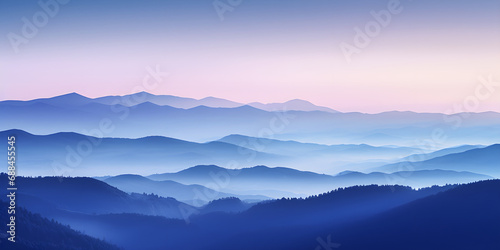 A silhouette of a mountain range with the first light of dawn breaking behind it illuminating the sky in soft pastels photo