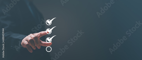 The confident businessman, with a decisive gesture, pointed to the checkmark on the form, approving the business application with finality. pointing, checklist, acceptance, choice