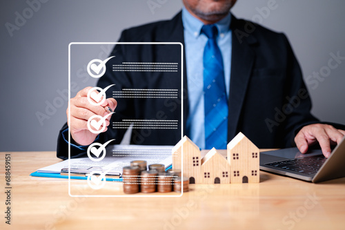 The meticulous businessman, armed with a comprehensive checklist, meticulously evaluated the investment property's potential before approving the mortgage loan. home, housing, estate photo