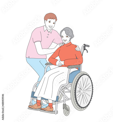 介護士に車椅子を押してもらうシニア女性 © natsu