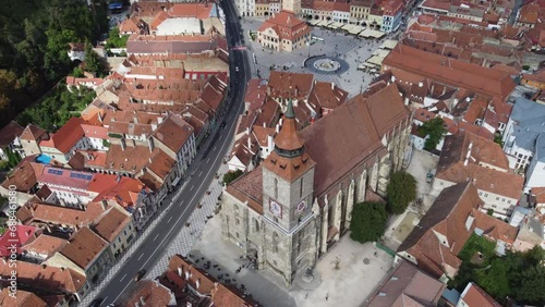 Backward aerial shot of Biserica Neagra showing Brasov, Romania.Wide tilt up
 photo