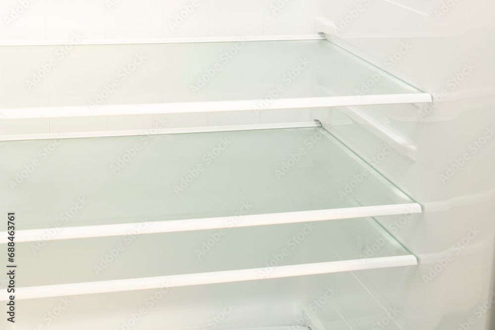 Empty refrigerator with open door Inside an empty, clean refrigerator, a refrigerator compartment after defrosting Empty refrigerator with open door Inside an empty, clean refrigerator, a refrigerator compartment after defrosting