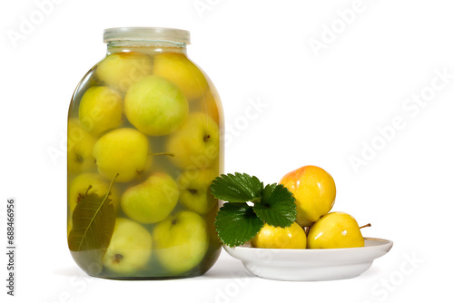 A jar of soaked apples. Plate with soaked apples on white background. Natural canned apples.