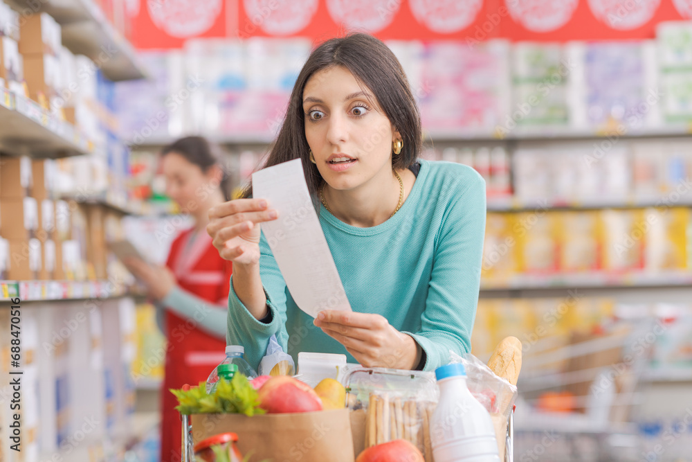 Woman checking an expensive grocery receipt