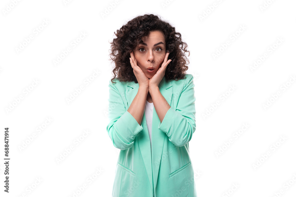 surprised young brunette curly businesswoman in a jacket on a white background surprised young brunette curly businesswoman in a jacket on a white background