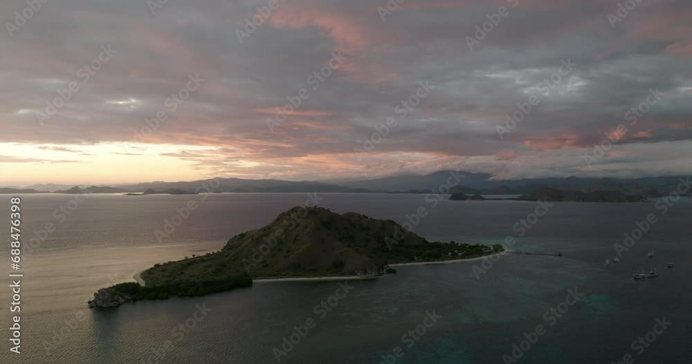 Aerial Panning Beautiful View Of Komodo Island In Sea Under Cloudy Sky During Sunset Aerial Panning Beautiful View Of Komodo Island In Sea Under Cloudy Sky During Sunset